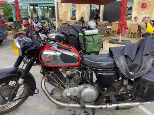 a row of motorcycles parked in a parking lot at Auberge de Marville in Marville