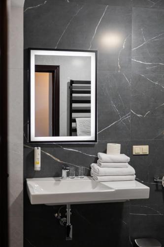 a bathroom with a sink and a mirror at Hotel Kopczyński in Dobre Miasto