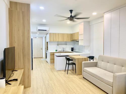a kitchen and living room with a couch and a table at Deco Home @ Aru Suites in Kota Kinabalu