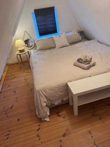 a bedroom with a large bed with a table at Altstadthaus No 18 in Lübeck