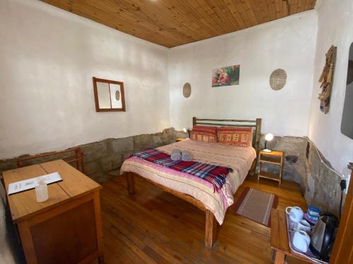 a bedroom with a bed and a wooden floor at Sani Lodge & Cottages in Sani Pass