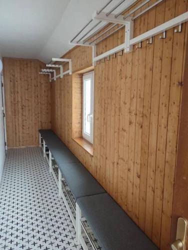 a room with wooden walls and benches and a window at Chalupa Herbortice in Cotkytle