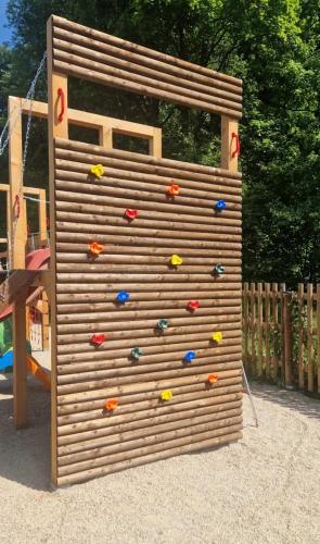 a climbing wall in a playground with colorful rocks at Chalupa Herbortice in Cotkytle