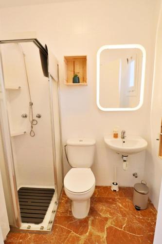 a small bathroom with a toilet and a sink at Antequera 49 in La Cala de Mijas