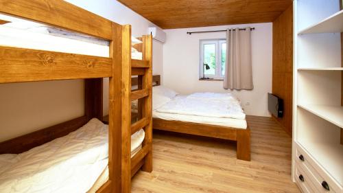 a bedroom with two bunk beds and a window at Chalupa Herbortice in Cotkytle