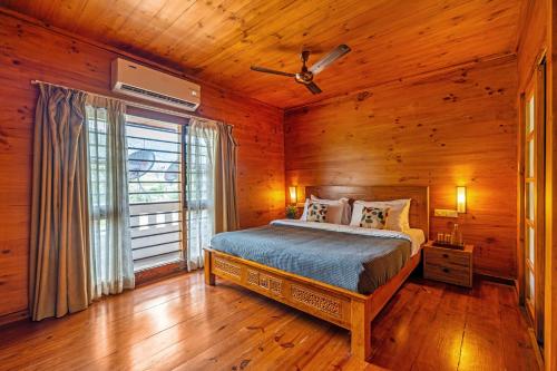 a bedroom with a bed and a ceiling fan at Senaro Farms in Varagampadi