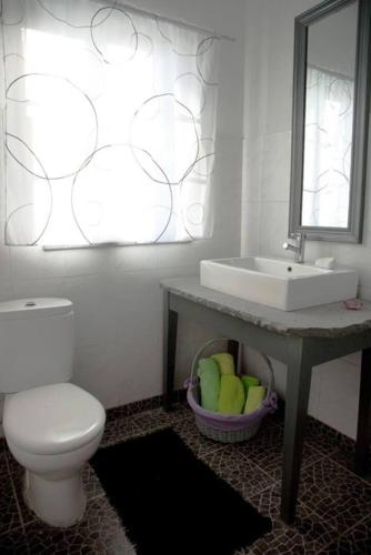 a bathroom with a white toilet and a sink at Pico Dreams in São Roque do Pico
