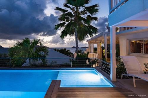 a swimming pool on the balcony of a house at Fresh Summer Villa with Superb View of the Hills in Quartier de Lorient