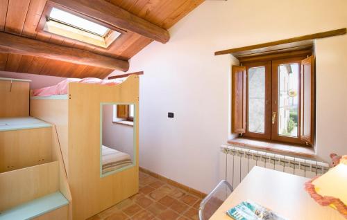 a room with a bunk bed with a desk and a window at Masseria Perugini in San Marco Argentano