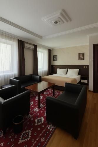 a hotel room with a bed and a red rug at Evergreen Hotel in Ulaanbaatar