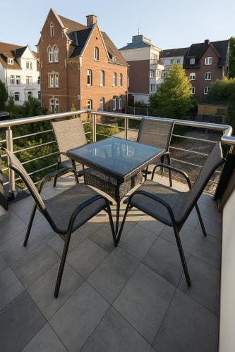 a table and two chairs on a balcony at Neubauwohnung in Siegen-Zentrum in Siegen