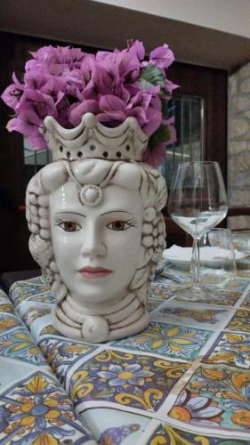 a statue of a head with a flower on a table at Fattoria F.lli Marsolo in Chiusa Sclafani
