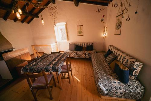 a living room with a table and a couch at Alloro casa storica in Arcola