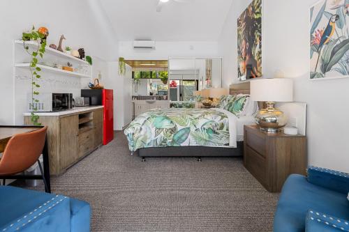 a bedroom with a bed and a kitchen at Private Suite Nautilus Beach Front Resort in Coffs Harbour
