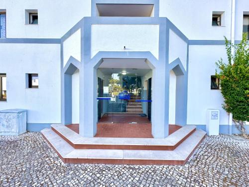 a white building with a staircase in the middle at Vilamoura Central 12 With Pool by Homing in Vilamoura