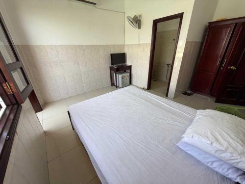 Postel nebo postele na pokoji v ubytování POP 1296 Phú Lộc Xuân Hotel Danang