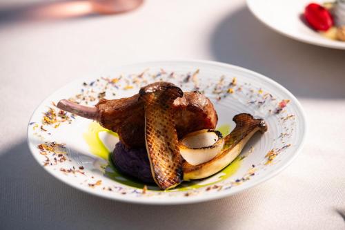 a plate of food with meat and bananas on a table at KRESTEN ROYAL Euphoria Resort in Kallithea Rhodes