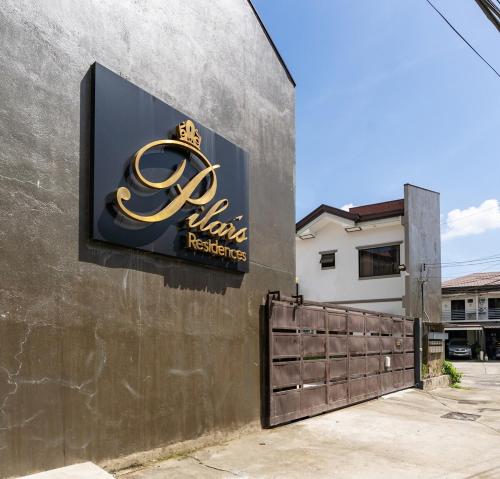 a sign for a restaurant on the side of a building at Furnished 3BR Townhouse Near Cebu IT Park with Parking, Fast WiFi, Netflix and More in Cebu City