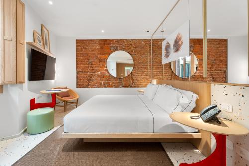 Un ou plusieurs lits dans un hébergement de l'établissement Hotel Milu Milano