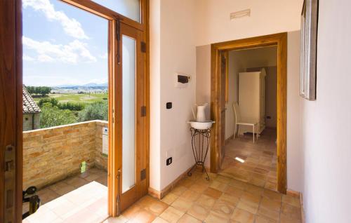 a hallway with a door open to a balcony with a view at Masseria Perugini in San Marco Argentano