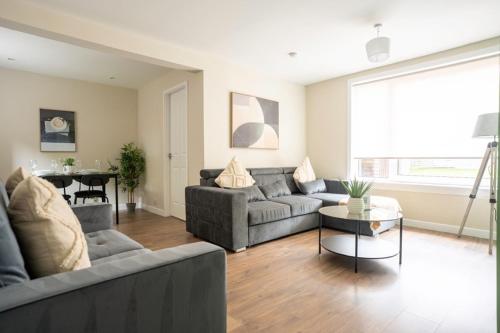 a living room with a couch and a table at Graham House in Livingston