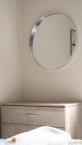 a mirror on top of a dresser in a bedroom at Graham House in Livingston