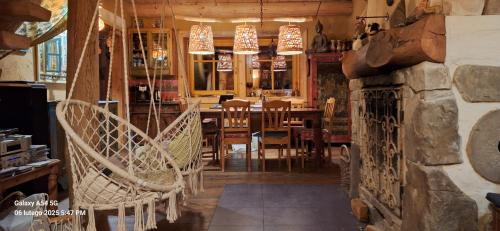 a dining room with a table and chairs at Beskid Masala in Ropki