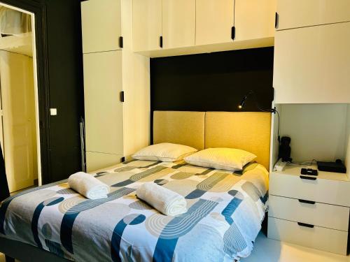 a bedroom with a bed with two pillows on it at Studio Malheux centre ville avec terrasse in Trouville-sur-Mer