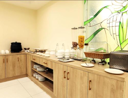 a kitchen with wooden cabinets and a stained glass window at VIVVA Premier Delhi Aerocity FREE Airport Pick Up in New Delhi
