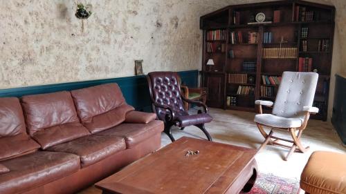 a living room with a couch and two chairs at La maison de Madeleine in Rochecorbon
