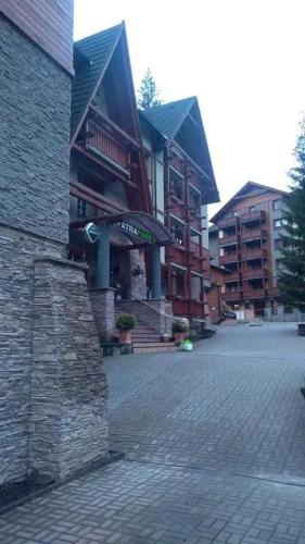 a building with a sign on the side of it at Apartmán Malinô Brdo Hrabovo Fatrapark 1 in Ružomberok