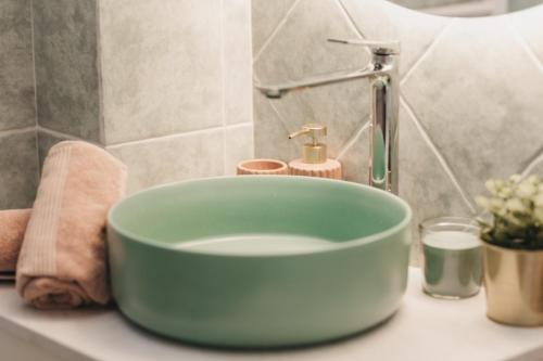 a blue bowl sink on a counter in a bathroom at Halkidiki Boho Pool Beach House in Gerakini