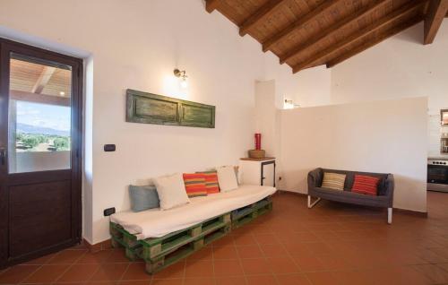 a living room with a couch and a chair at Masseria Perugini in San Marco Argentano
