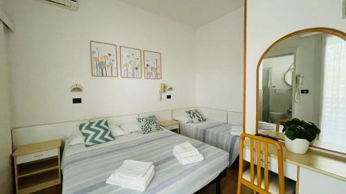 Ένα ή περισσότερα κρεβάτια σε δωμάτιο στο Albergo Villa Denny