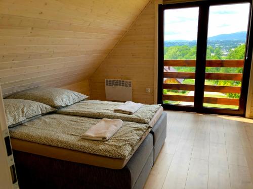 a bedroom with a bed with two towels on it at Staś in Zarzecze