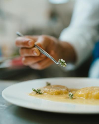 a person holding a fork and a plate of food at Masseria Corsano in Nardò
