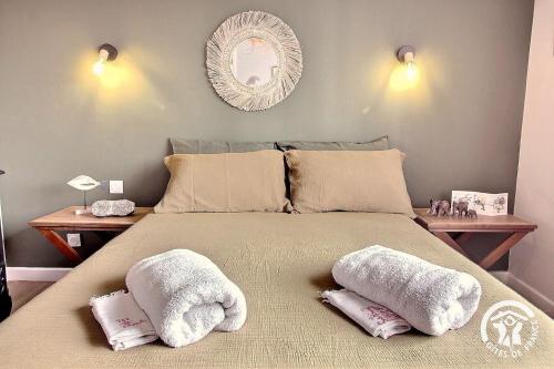 a bedroom with a large bed with towels on it at Chez lili in Saint-Brieuc