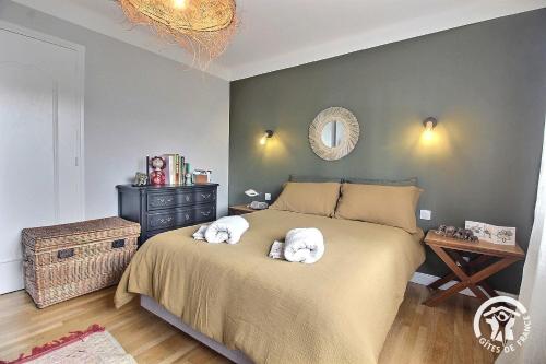 a bedroom with a bed with two towels on it at Chez lili in Saint-Brieuc