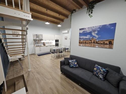 a living room with a couch and a dining room at Cuncittina's Home in Pachino