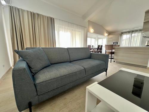 a living room with a couch and a table at Kumbor summer holiday in Topla