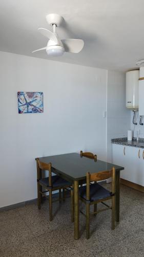 a dining room table and two chairs in a kitchen at Apartaments El Sorrall in Blanes