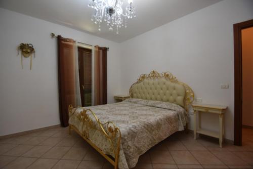 a bedroom with a bed and a chandelier at Casa DiVa in Terni