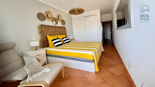 ein Schlafzimmer mit einem Bett und einer Couch in der Unterkunft Mar à Vista Lagos in Lagos