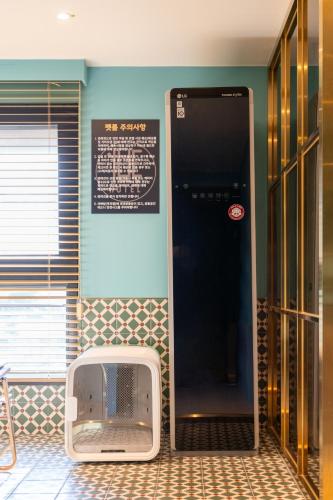 a bathroom with a sign on the wall next to a machine at Hotel Ippda Wonju in Wonju