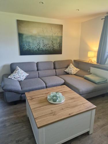 a living room with a couch and a coffee table at Ferienwohnung Landglück in Haale