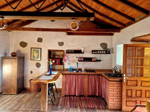 a kitchen with a table and a counter top at La Escuelita in Montaña Alta