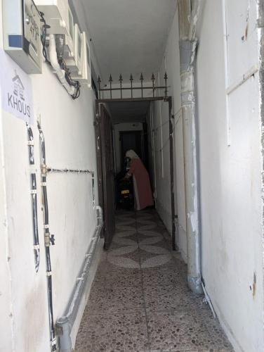 a person sitting in a chair in a hallway at The guest house in Port Louis