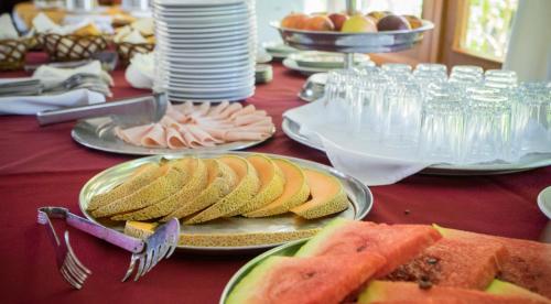 a table with plates of food on a red table at Hosteria Del Pescador in Punta Del Diablo