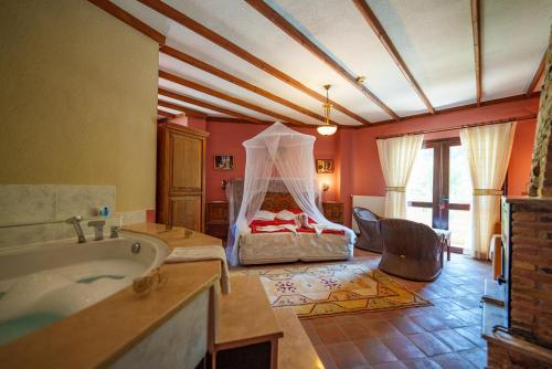 a bathroom with a tub and a bed in a room at Efes Butik Otel in Kirazli