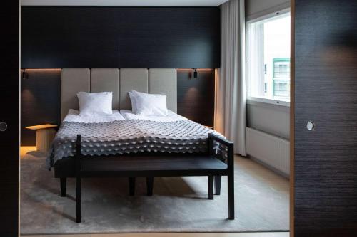 a bedroom with a bed with a black headboard at Scandic Helsinki Aviacongress in Vantaa